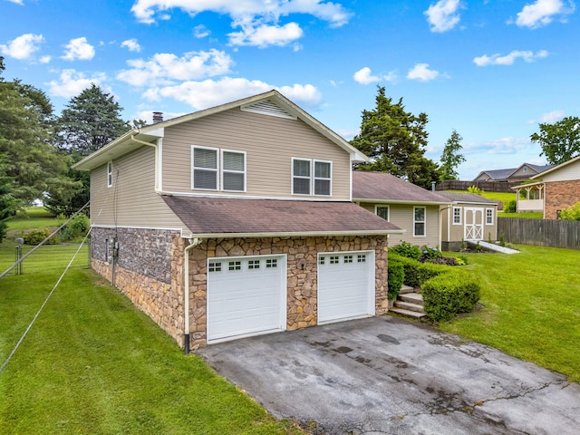 5715 Academy Dr, Morristown, TN 37814 - view of front of home with stone siding, asphalt driveway, an attached garage, roof with shingles, and a chimney