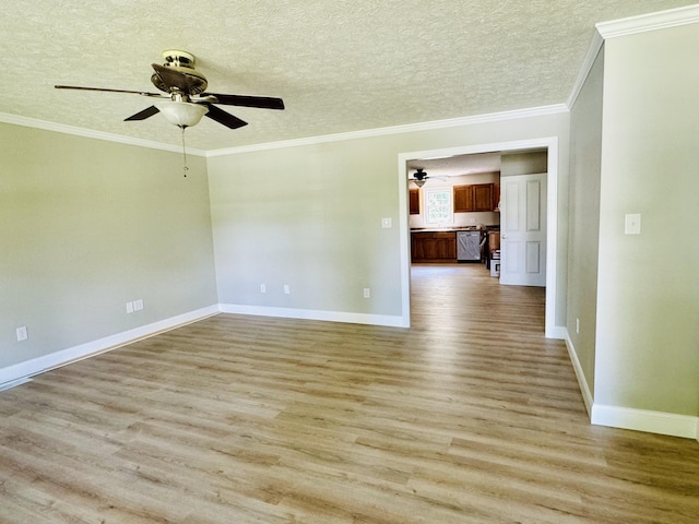 spare room with a textured ceiling, light hardwood / wood-style flooring, ceiling fan, and crown molding