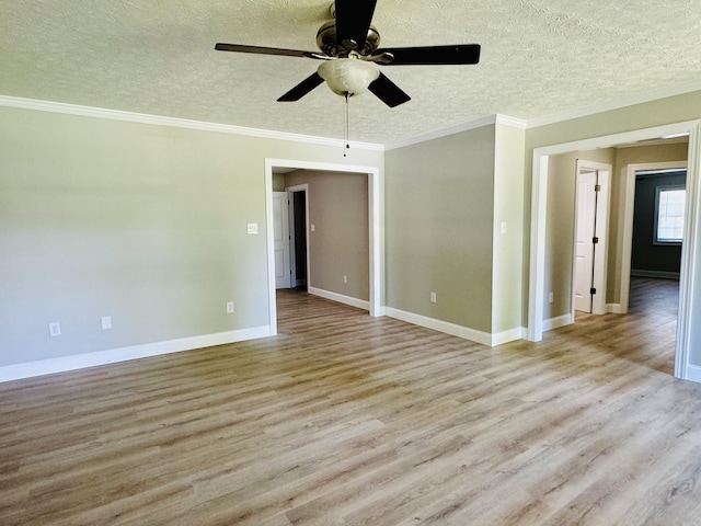 spare room featuring ceiling fan, light hardwood / wood-style floors, and crown molding