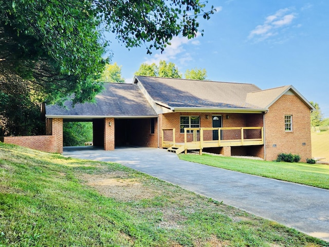 single story home featuring a carport, a deck, and a front yard