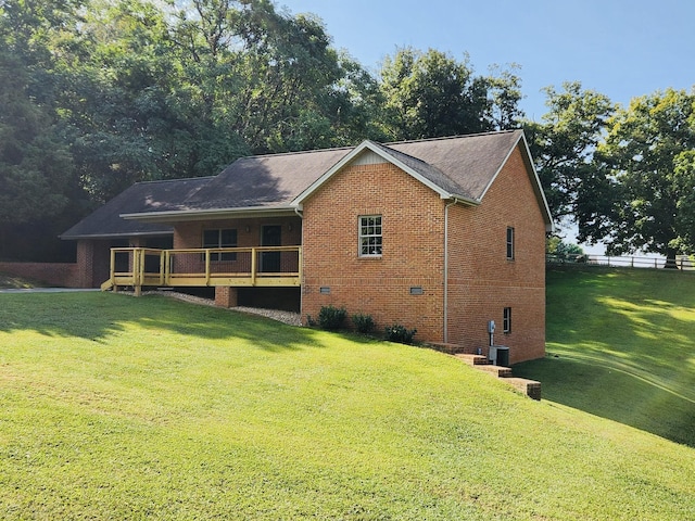 rear view of house with central AC, a yard, and a deck