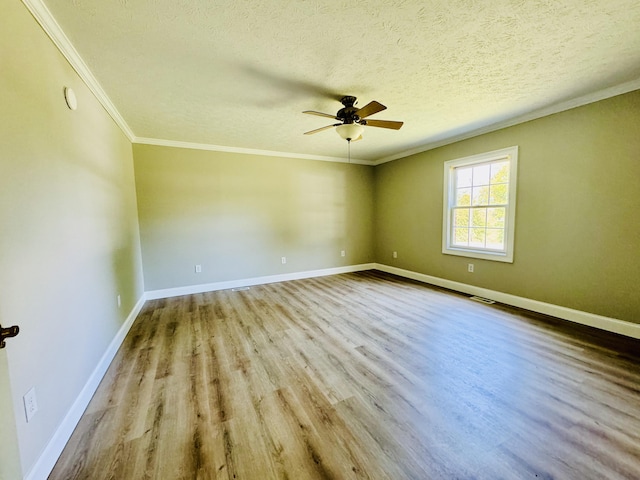 spare room featuring ceiling fan, light hardwood / wood-style floors, crown molding, and a textured ceiling