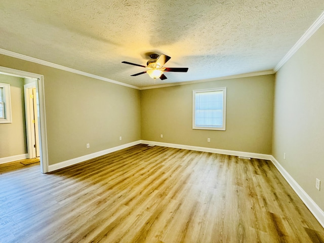 empty room with ceiling fan, light hardwood / wood-style floors, a textured ceiling, and ornamental molding