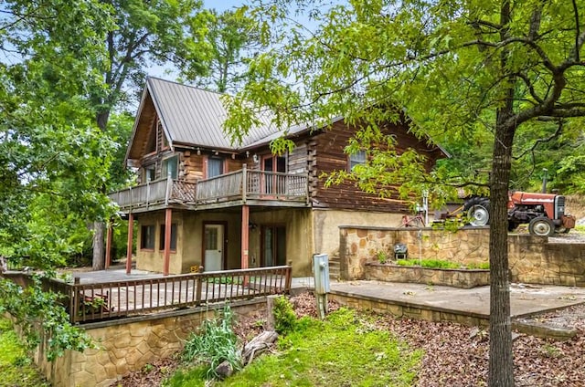 1370 Flat Woods Rd, Dandridge, TN 37725 - view of front of house with log siding, a patio, a deck, and a metal roof