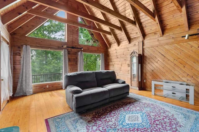 1370 Flat Woods Rd, Dandridge, TN 37725 - living area with wooden walls, a wood ceiling with exposed beams, wood-type flooring, and high vaulted ceiling