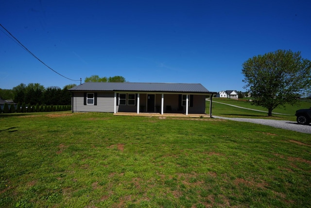 view of front of house featuring a front lawn and metal roof
