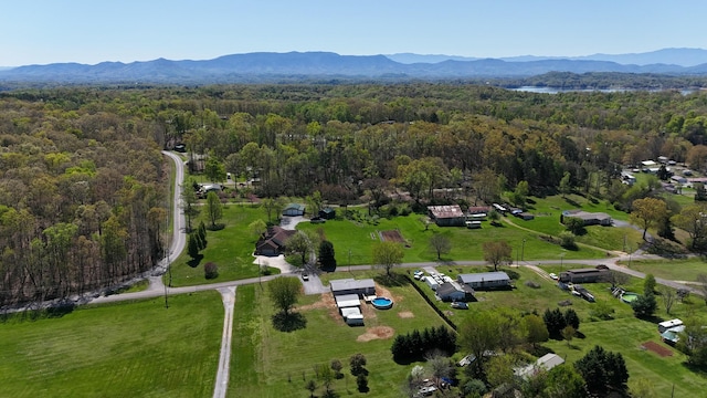 drone / aerial view featuring a wooded view and a mountain view