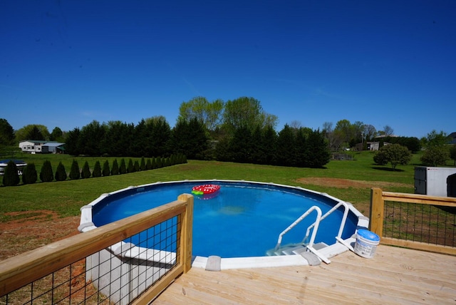 pool with a deck and a lawn