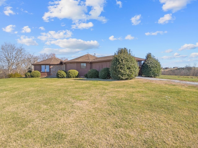 single story home featuring a front lawn