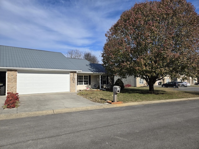 view of front of house with a garage and a front lawn