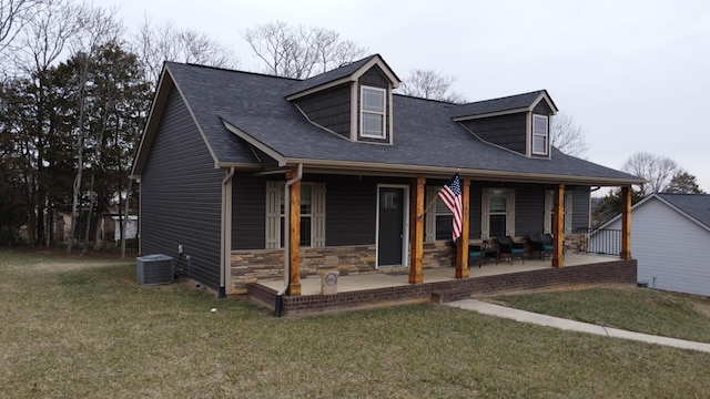 cape cod home featuring a patio area, central AC, a front lawn, and a porch