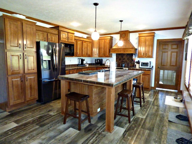 2115 Rambling Rose Ln, Jefferson City, TN 37760 - kitchen with custom range hood, black microwave, fridge with ice dispenser, and brown cabinets