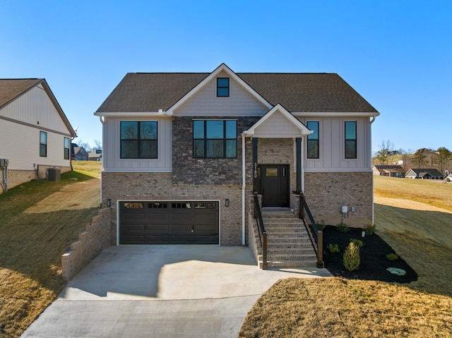 view of front of home with a garage, concrete driveway, central air condition unit, a front lawn, and board and batten siding