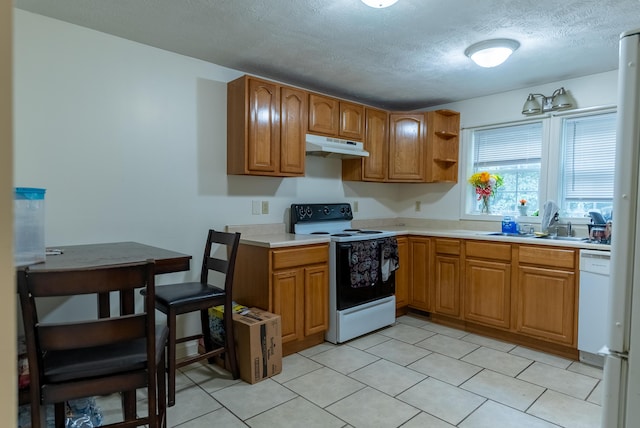 kitchen featuring sink, white appliances, and a textured ceiling