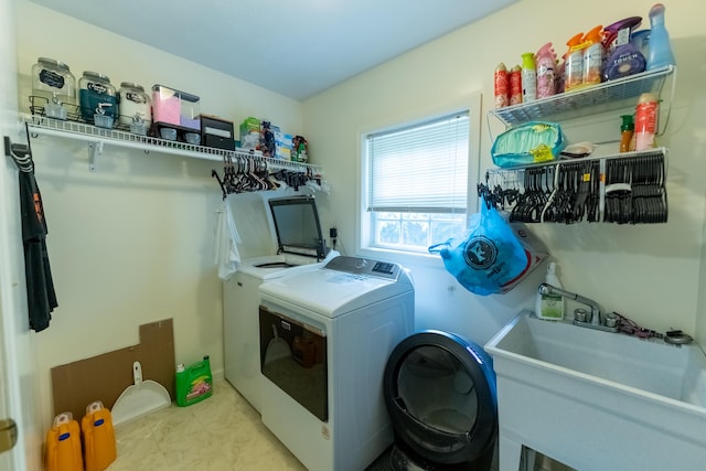 washroom featuring separate washer and dryer and sink