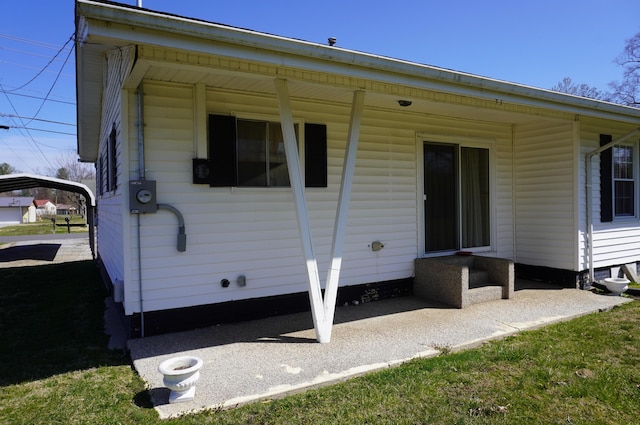 rear view of property with a detached carport and covered porch