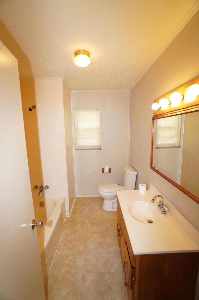 full bathroom with vanity, crown molding, tile patterned floors, toilet, and a bathtub