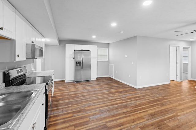 kitchen featuring visible vents, ceiling fan, wood finished floors, stainless steel appliances, and recessed lighting