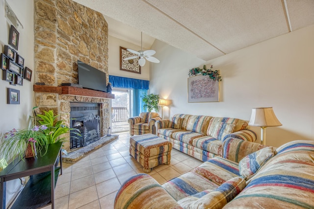 tiled living room featuring a fireplace, ceiling fan, a textured ceiling, and high vaulted ceiling