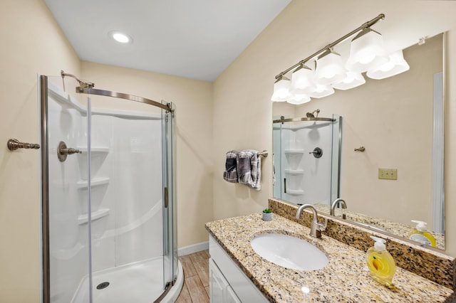 bathroom featuring vanity and a shower with shower door