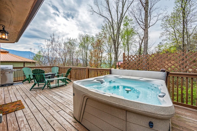 deck with a grill and a hot tub