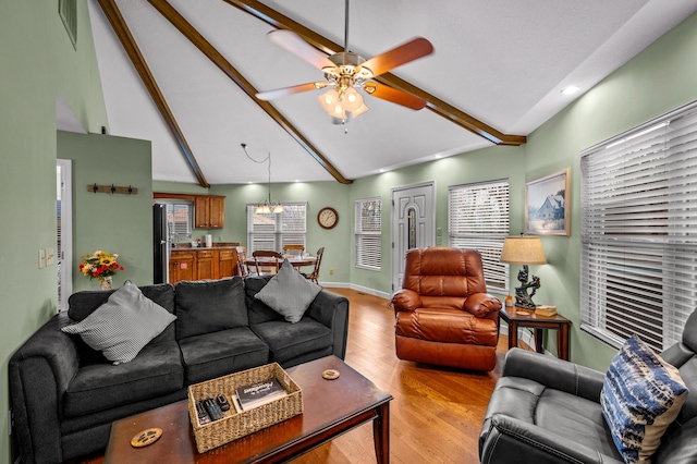 living room featuring beamed ceiling, ceiling fan with notable chandelier, high vaulted ceiling, and light hardwood / wood-style flooring