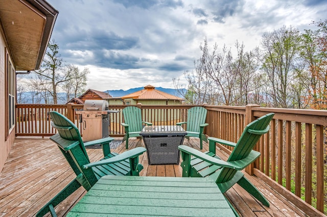 wooden terrace featuring area for grilling