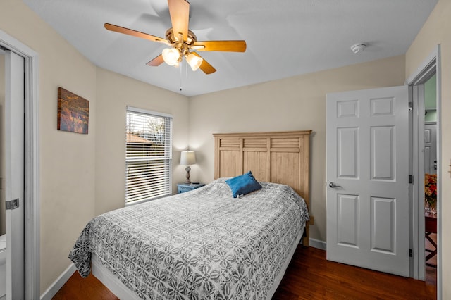 bedroom with ceiling fan and dark hardwood / wood-style floors