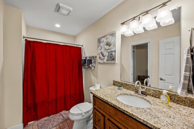 bathroom with a shower with shower curtain, vanity, and toilet