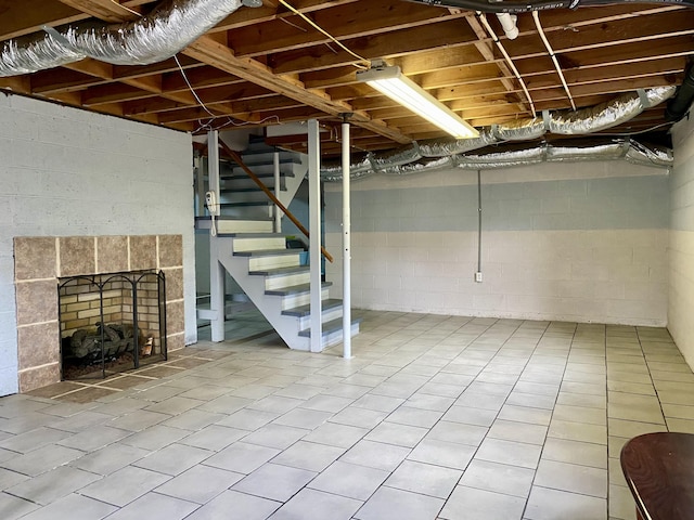 basement with a tiled fireplace