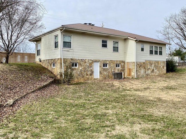 rear view of property with a yard and central AC