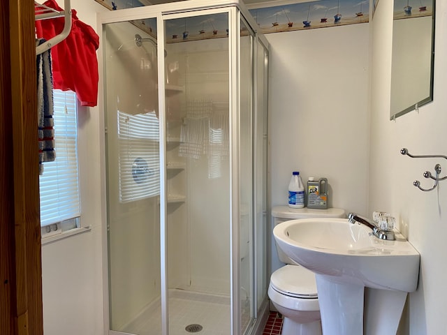 bathroom featuring toilet, tile patterned flooring, and walk in shower