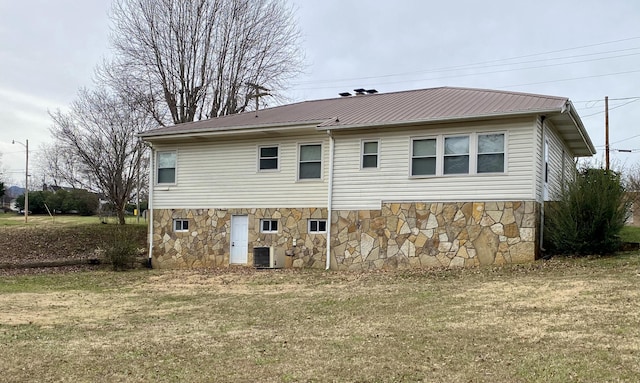 rear view of property featuring a yard and central AC