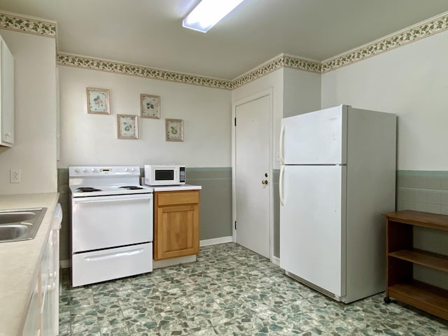 kitchen featuring white appliances and sink