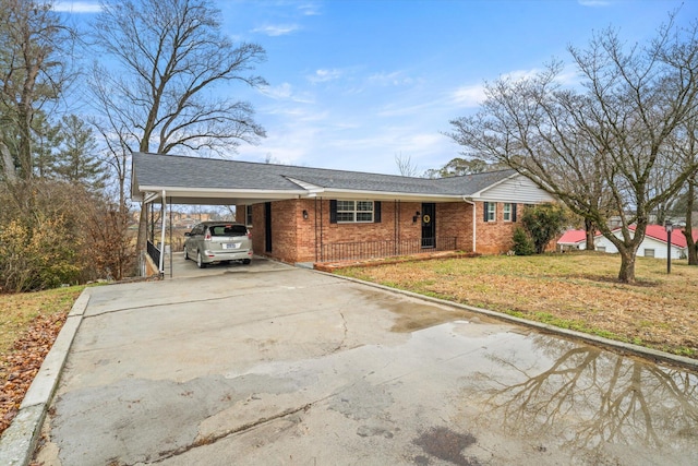 ranch-style home with a front yard and a carport