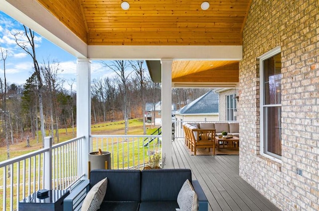 wooden deck with an outdoor living space