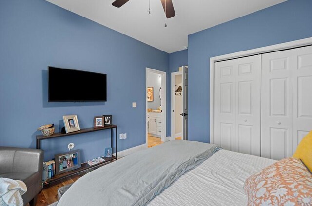 bedroom featuring a closet, baseboards, wood finished floors, and a ceiling fan