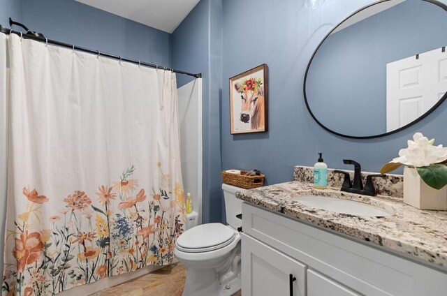 full bath with toilet and vanity