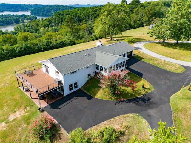 birds eye view of property with a water view and a view of trees