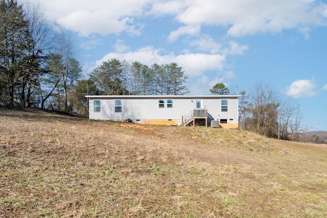 back of house featuring crawl space