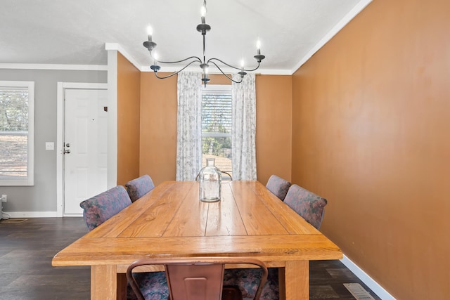 dining area featuring baseboards, dark wood-type flooring, an inviting chandelier, and crown molding