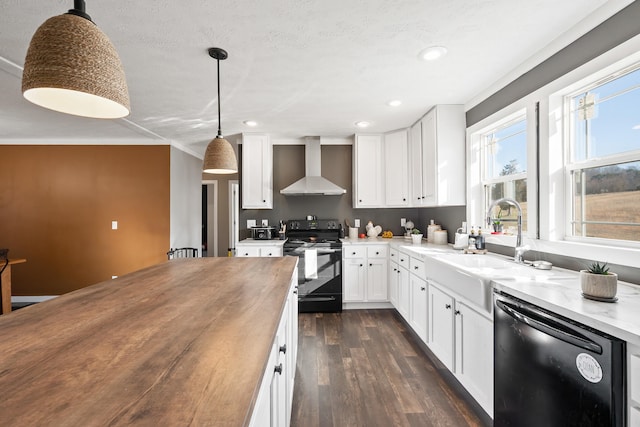 kitchen with black appliances, wood counters, dark wood finished floors, wall chimney exhaust hood, and white cabinets