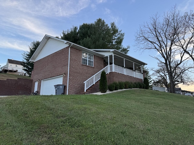 property exterior at dusk featuring a porch, a garage, and a lawn