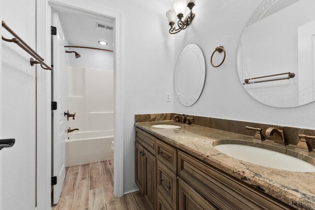 full bathroom with shower / bathing tub combination, vanity, and toilet