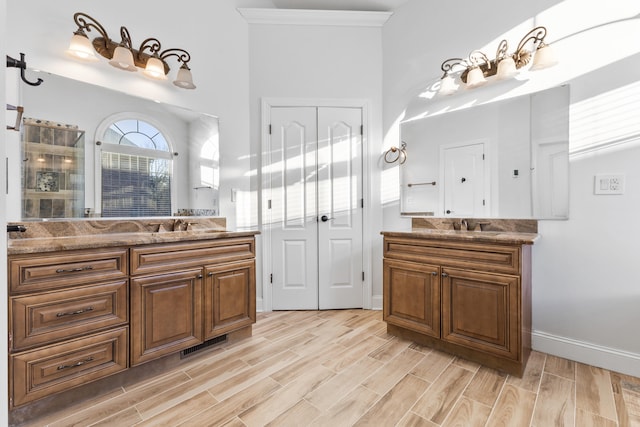 bathroom with ornamental molding, walk in shower, and vanity