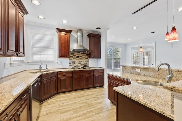 kitchen featuring stainless steel dishwasher, wall chimney exhaust hood, sink, and pendant lighting