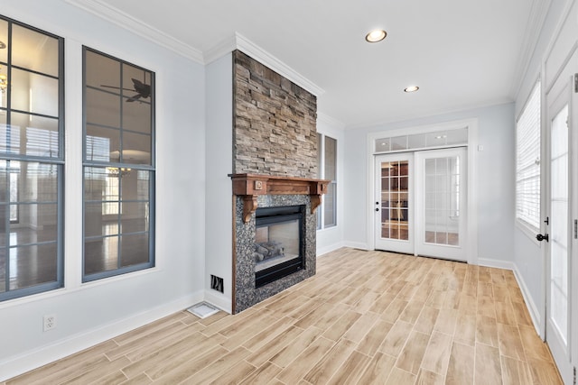 unfurnished living room with ceiling fan, light hardwood / wood-style flooring, ornamental molding, and a fireplace