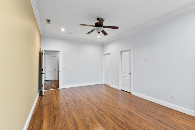 unfurnished room with ceiling fan, dark wood-type flooring, and crown molding