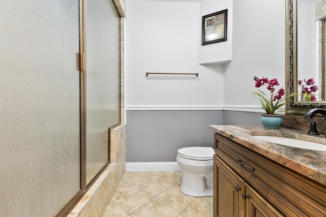 bathroom with an enclosed shower, vanity, tile patterned flooring, and toilet