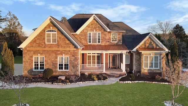 craftsman-style house with covered porch and a front lawn